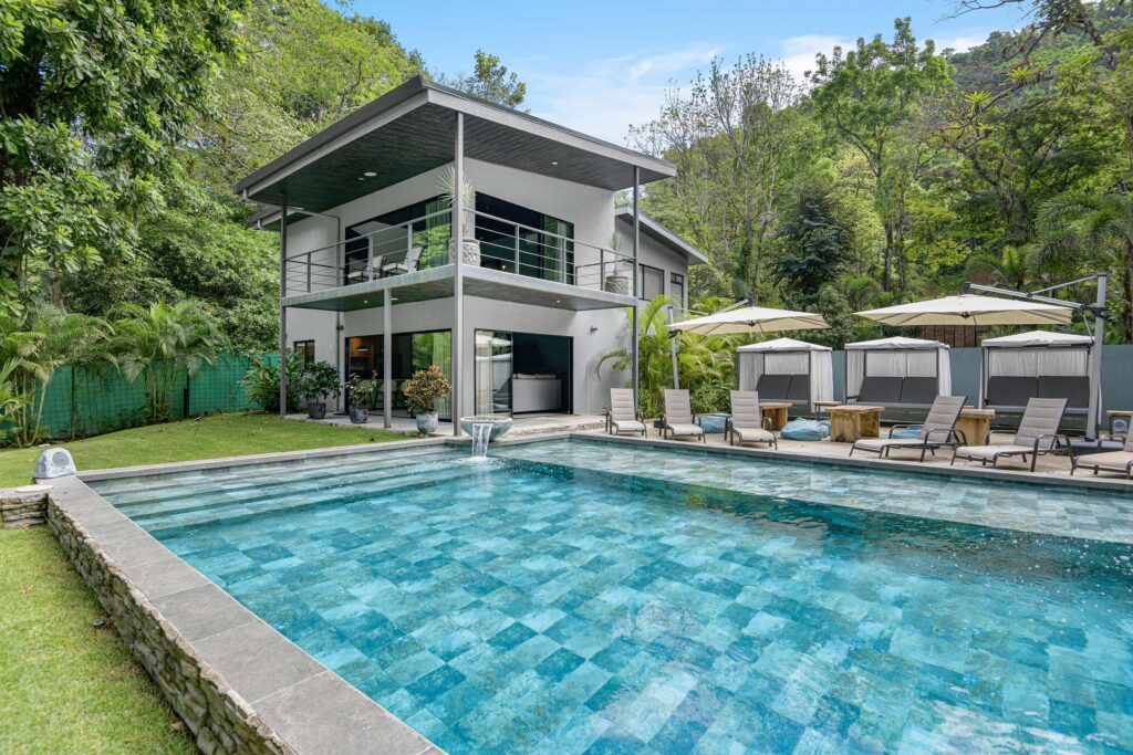 View of the main house from the garden with a beautiful pool at Seven Ranch