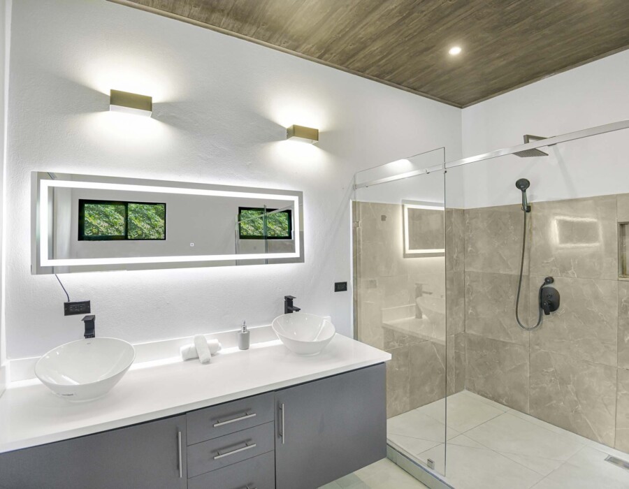 Modern master bathroom with double shower and double sink in Seven Ranch