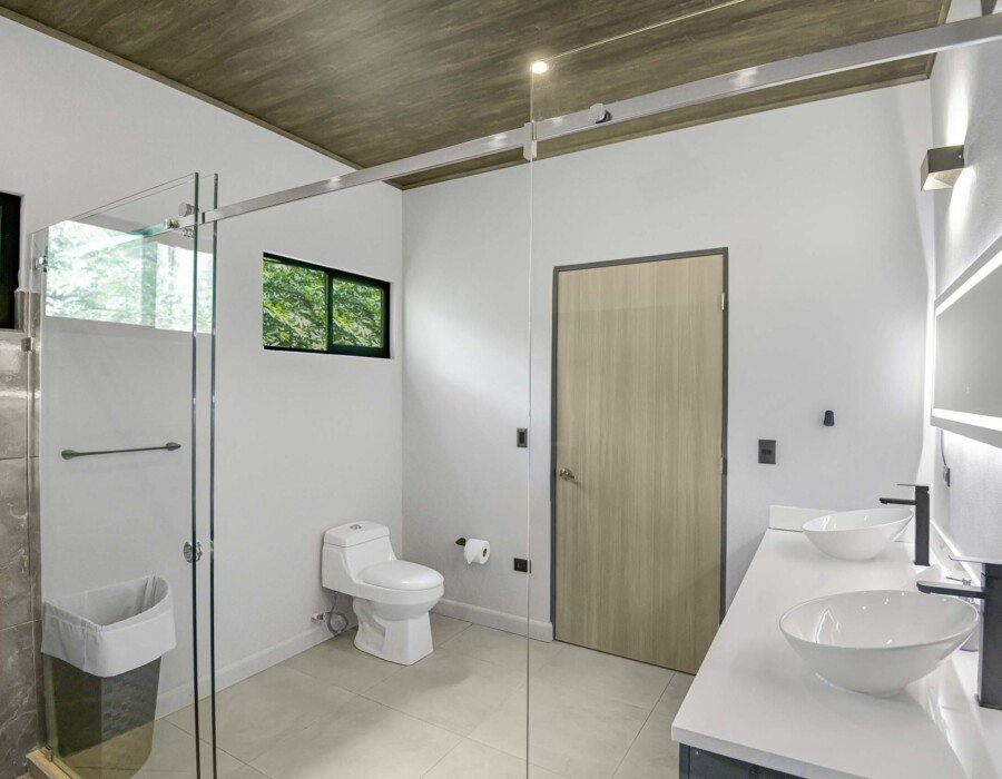 Modern bathroom with double shower and double sink in Seven Ranch