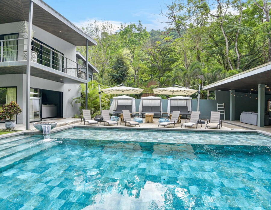 View of the pool with sun loungers and three private tents for lounging at Seven Ranch