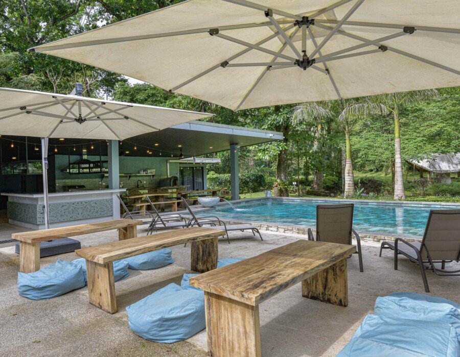 Poolside social lounge area at Seven Ranch with garden and river views