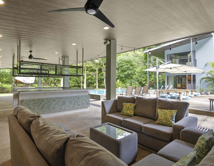 Large outdoor living room with a sofa to enjoy near the pool at Seven Ranch