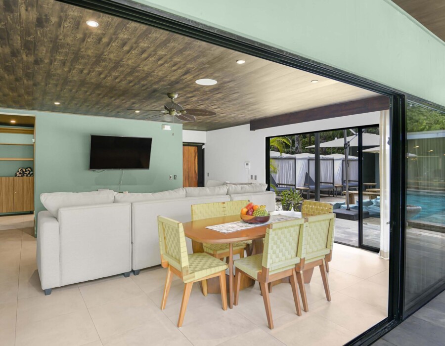 Dining and living room with large windows opening onto the garden in Seven Ranch