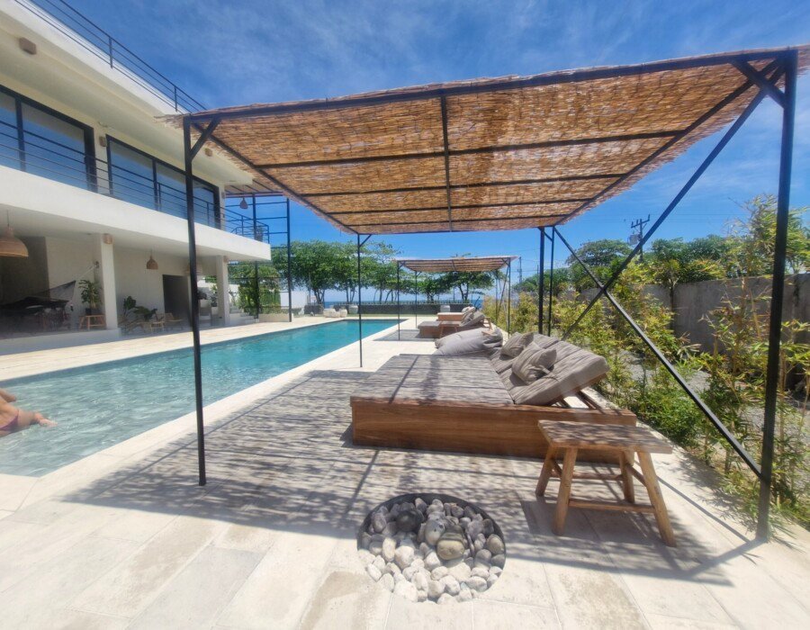 Poolside daybeds with ocean view in Jaco Costa Rica luxury villa