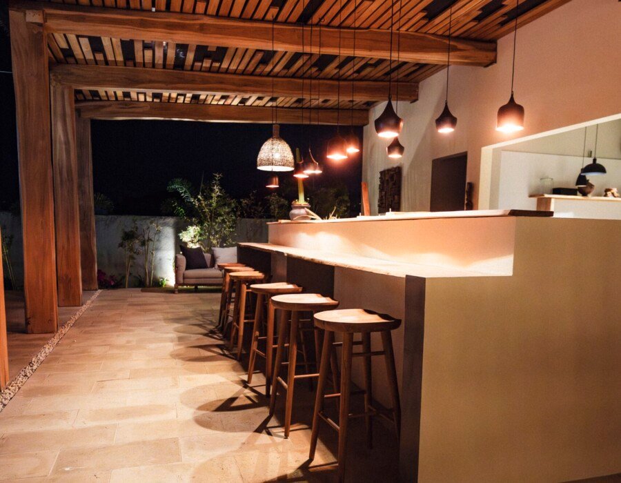 Night view of bar lounge with warm lighting in Playa Hermosa estate