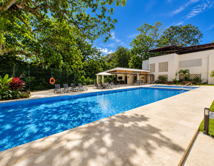 Outdoor pool with tropical garden views at Casa Live 1708
